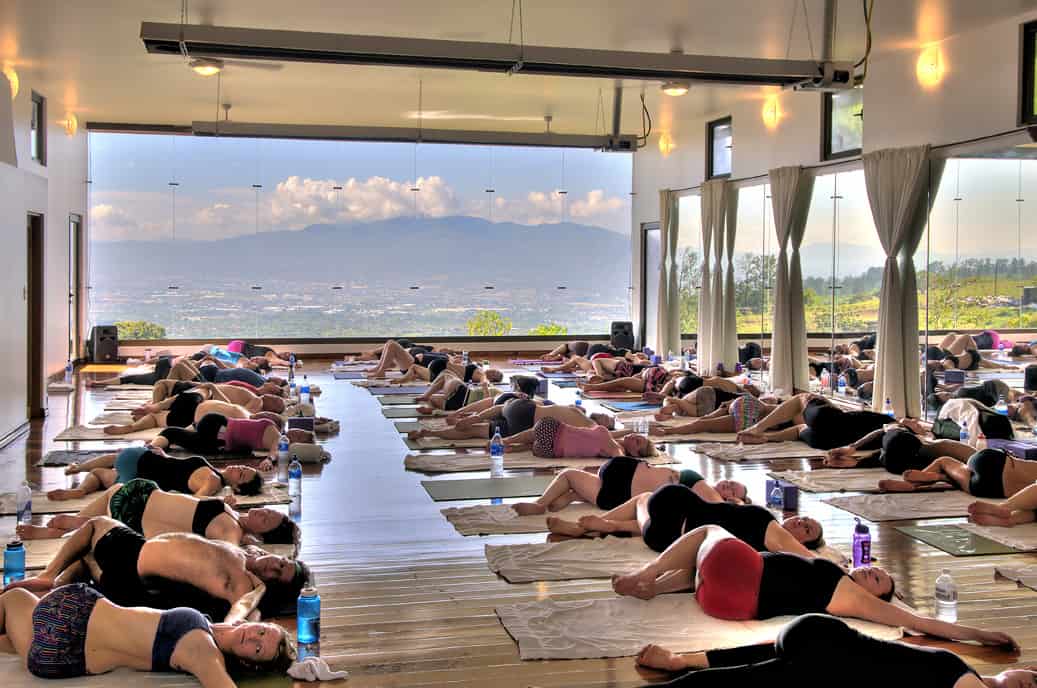 Group of students in spine twisting pose at a Hot Yoga Retreat in Costa Rica